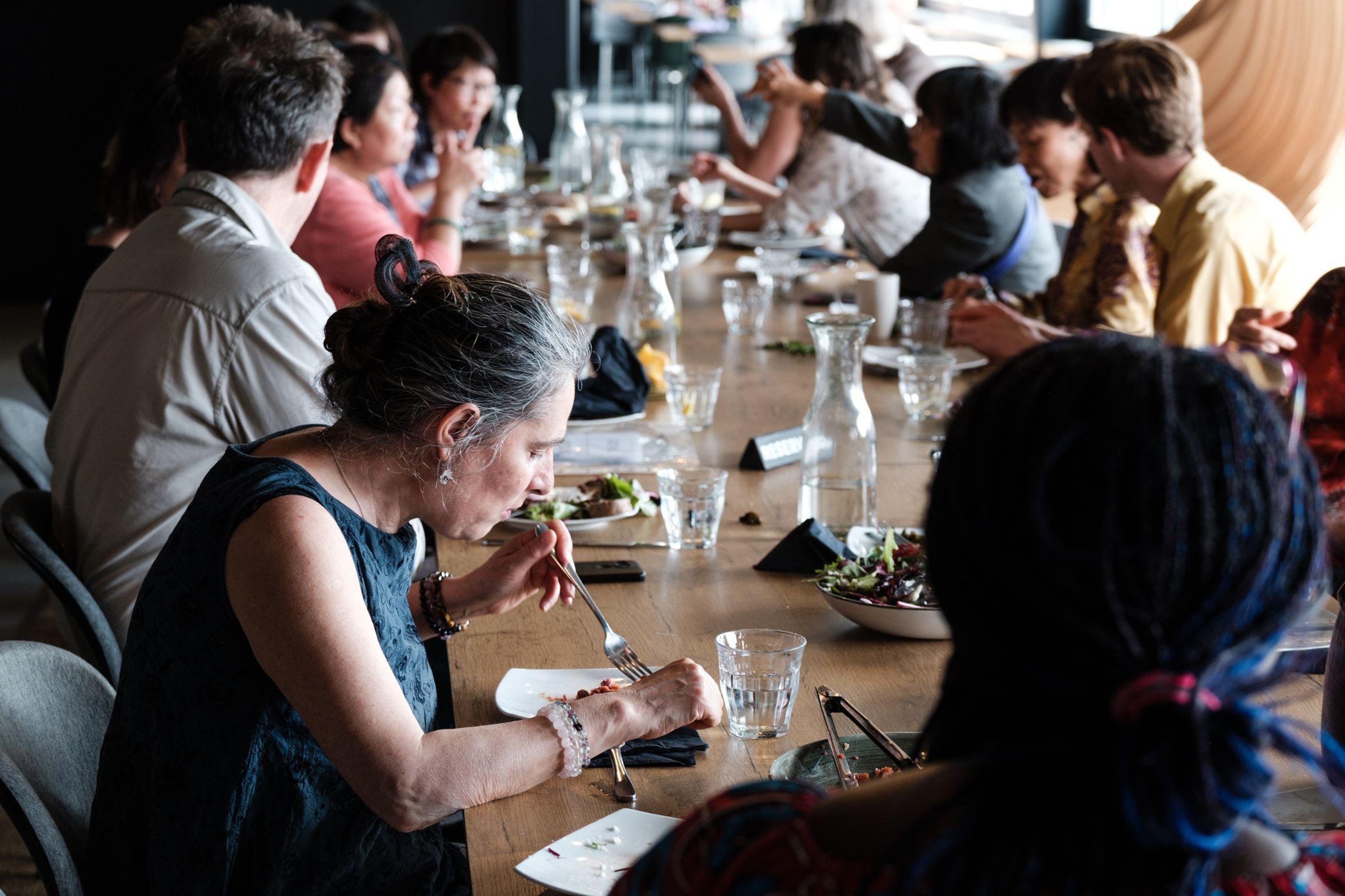 A large group of people eating around a table