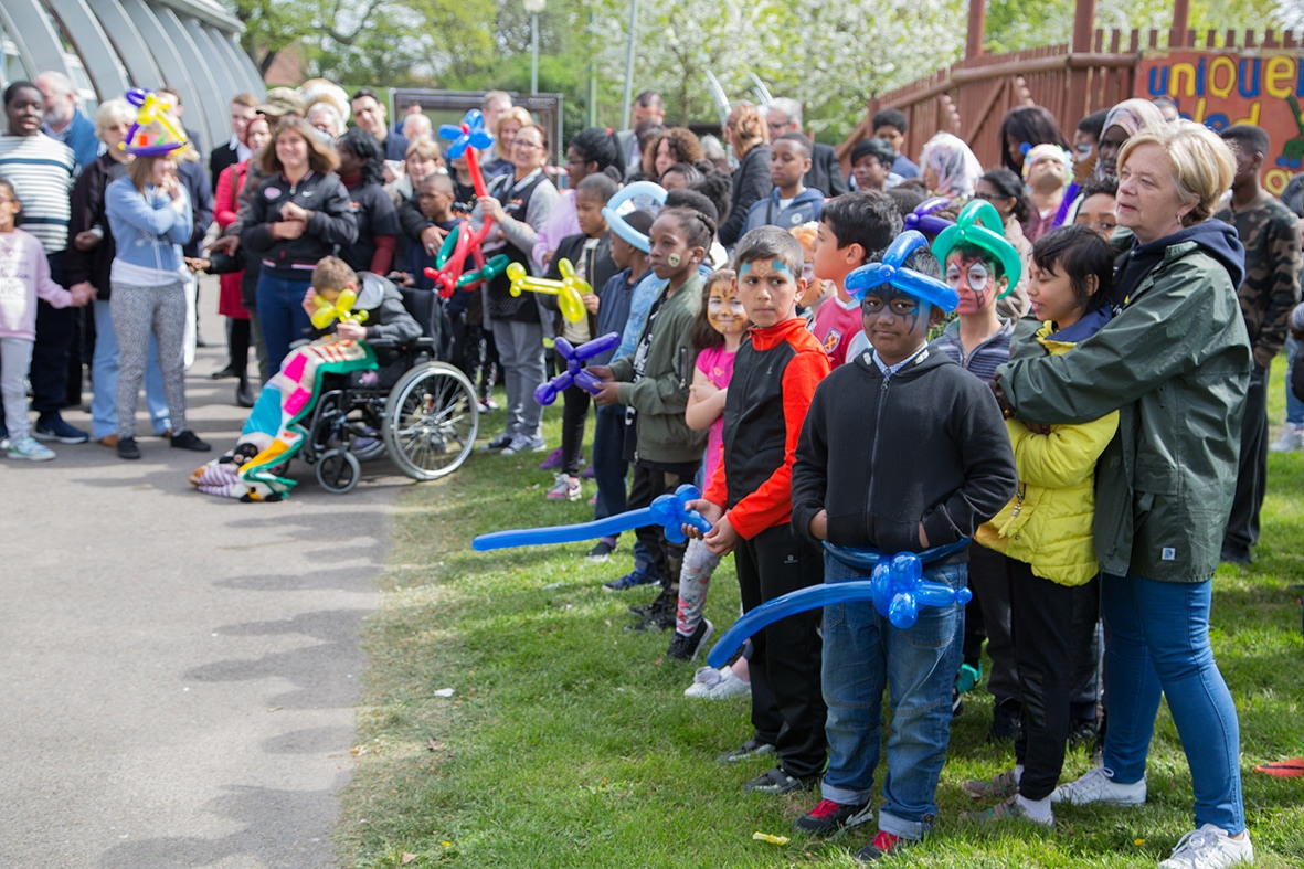 A group of children and parents with balloons