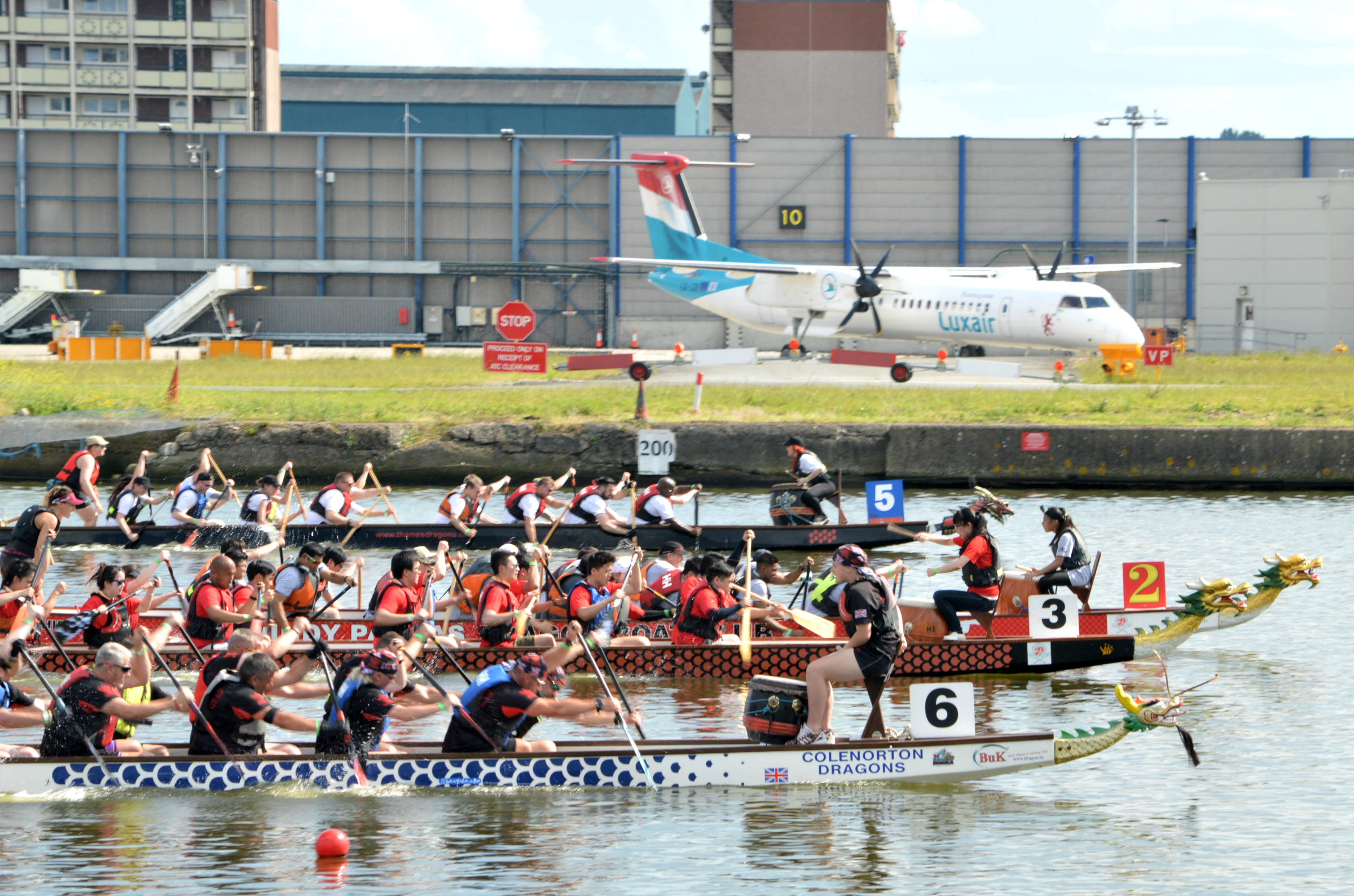 Three dragonboat teams racing at the Royal Docks