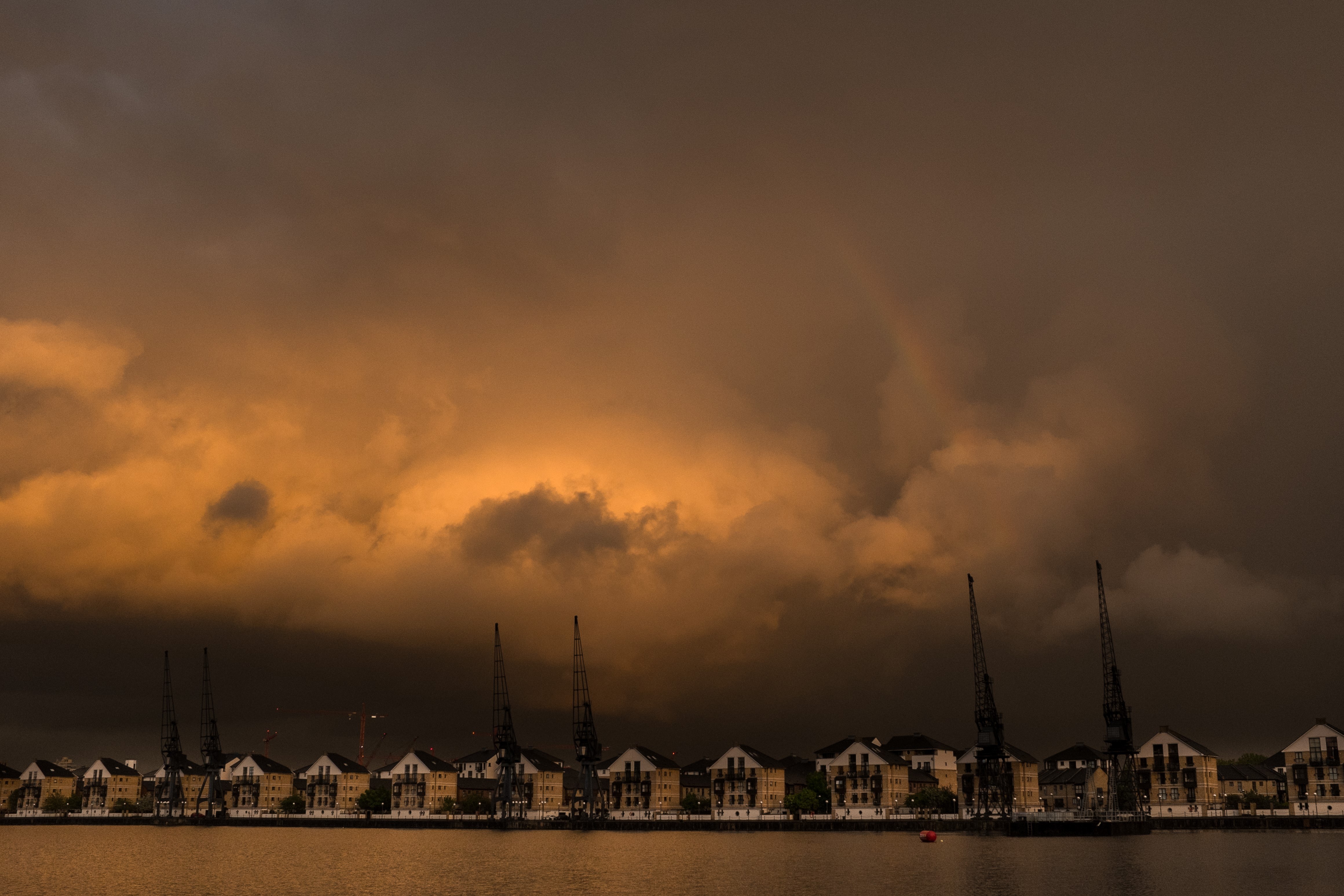 A photo of buildings along the Royal Docks with a moody and dramatic skyline