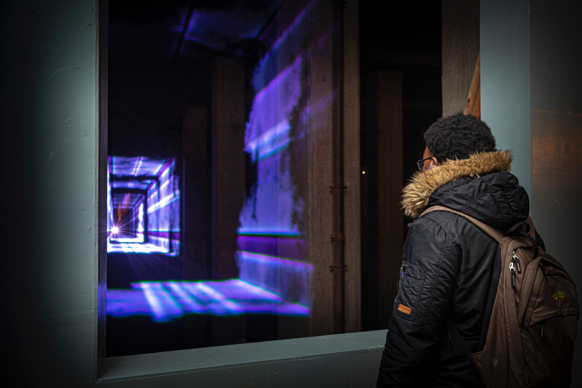 A young man watching Presence by Marcus Lyall