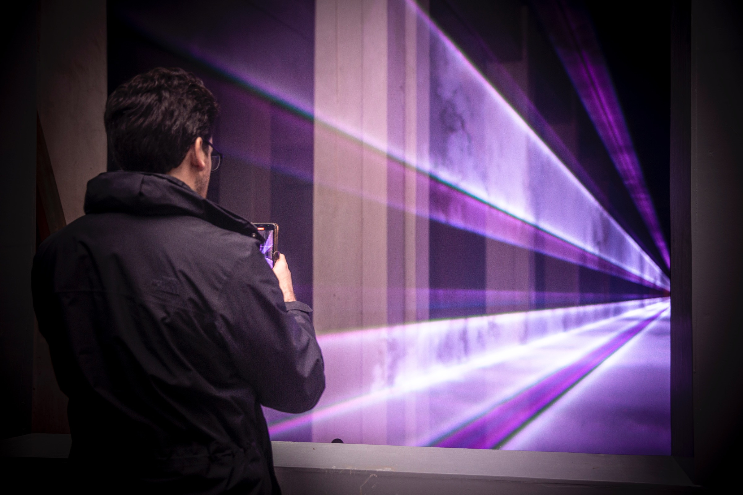 A man taking a photo of the Presence installation by Marcus Lyall