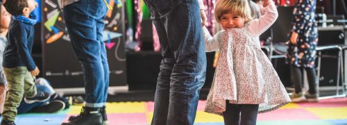 Children dancing on a bright coloured floor