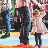 Children dancing on a bright coloured floor