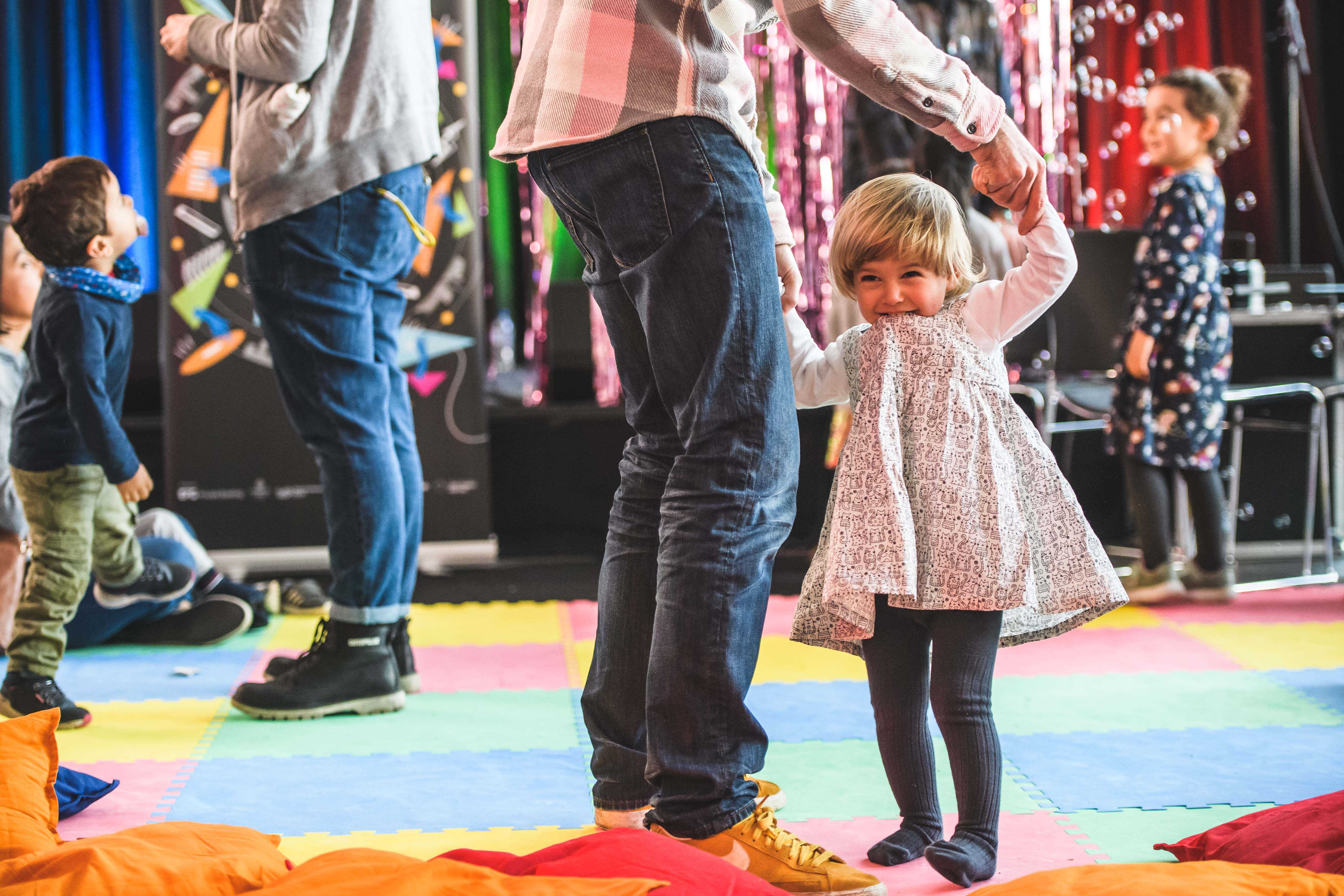 Children dancing on a bright coloured floor