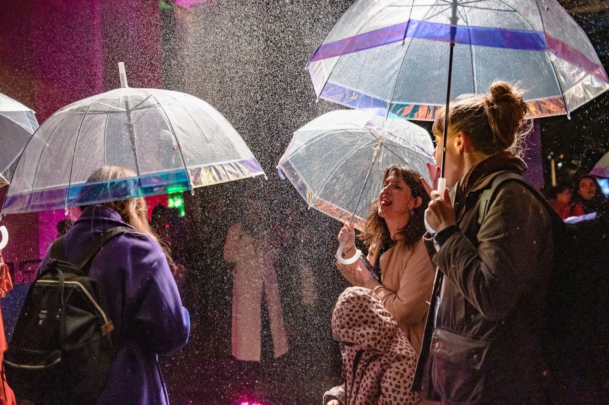 People under umbrellas in the flavour rainbow