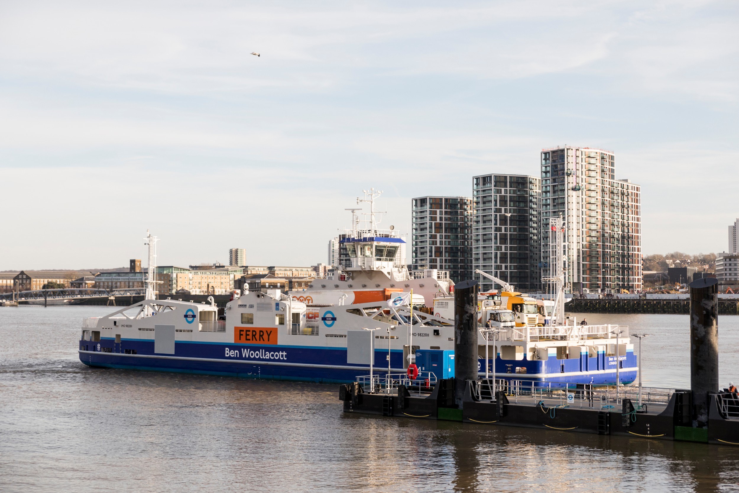 Ferry leaving its quay with Woolwich towers in the background