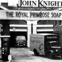 A yard with vans and signage that reads, "John Knight"
