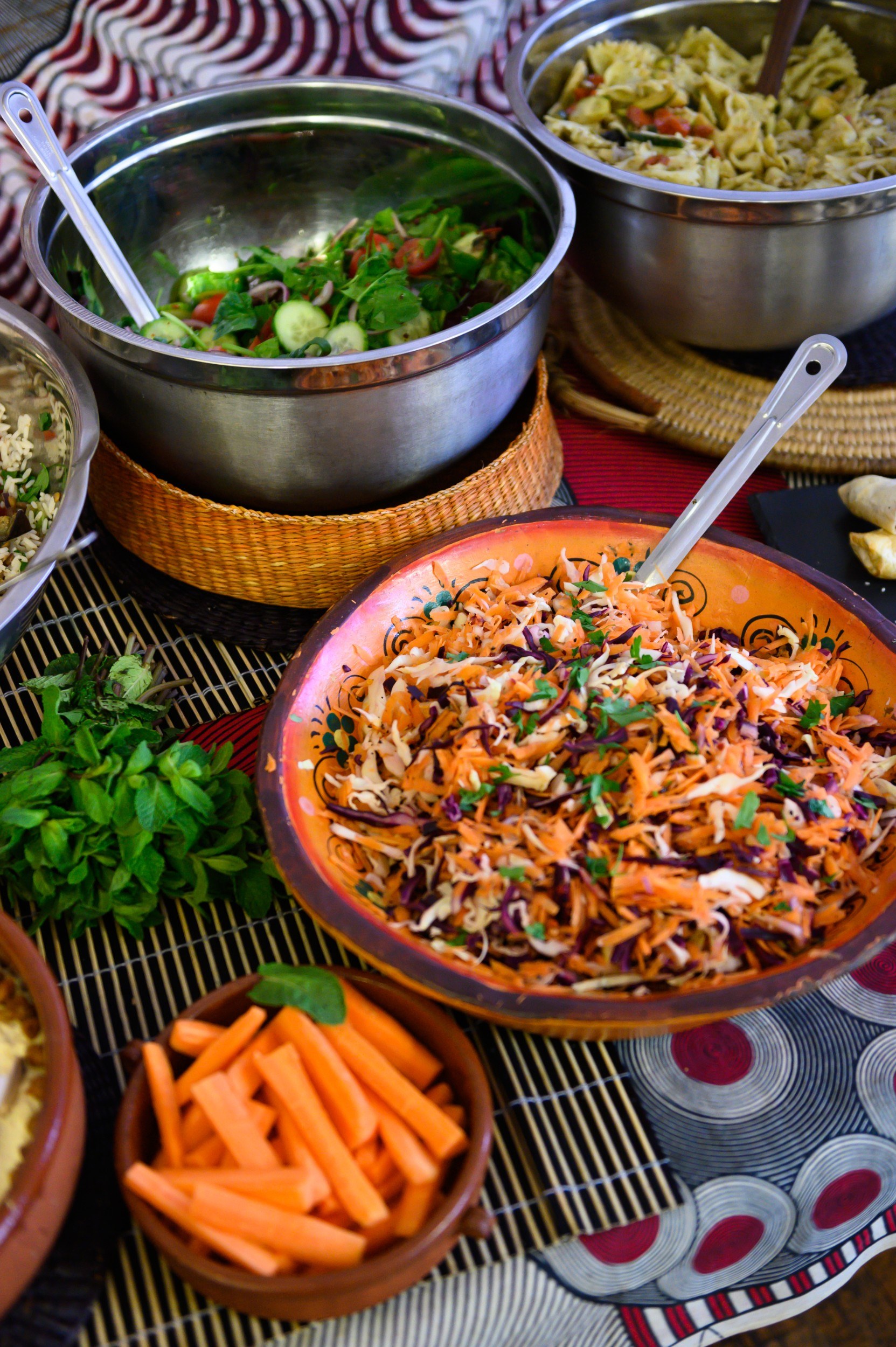 Four different bowls filled with colorful food