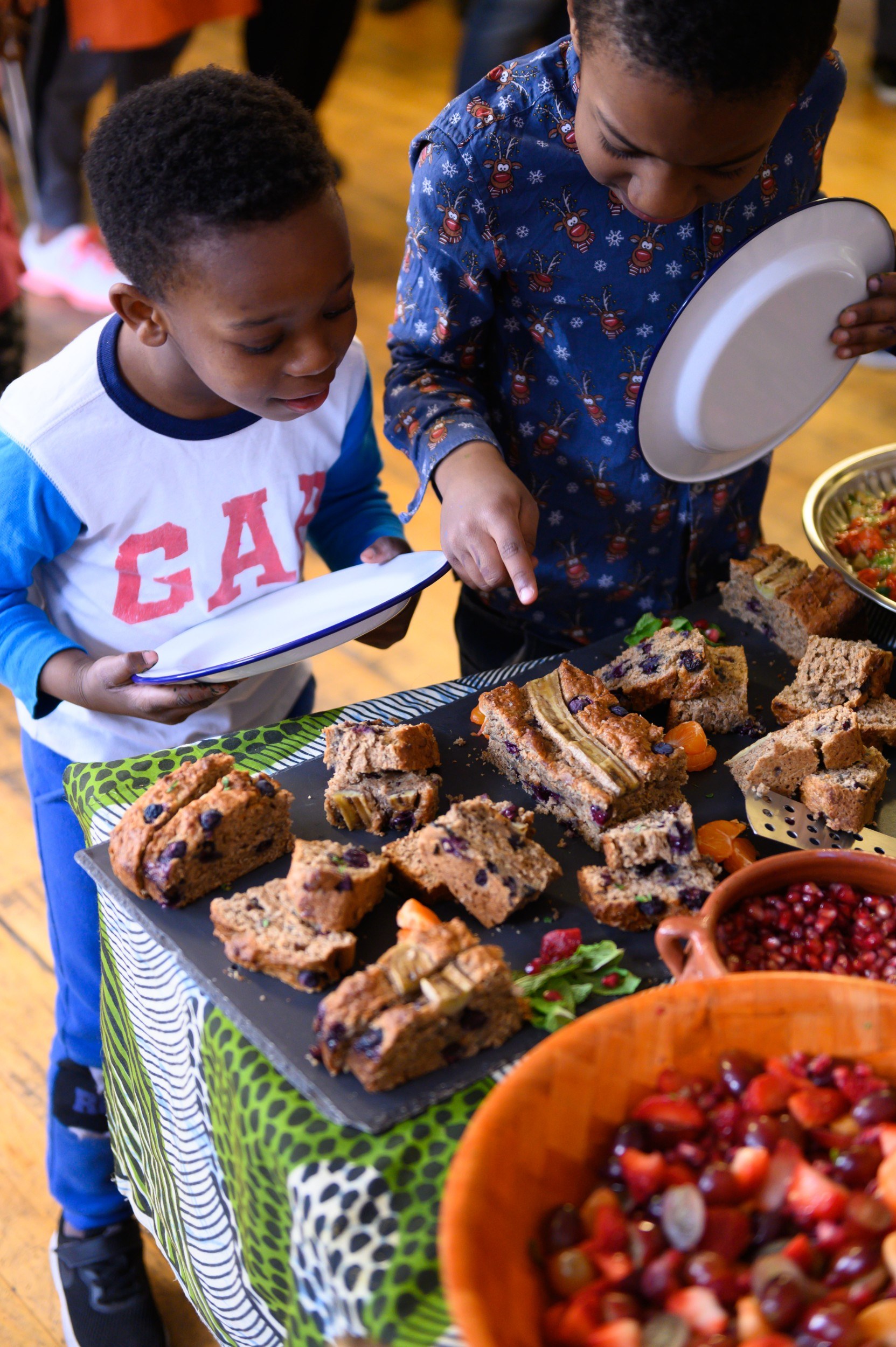 Two children choosing between items of food
