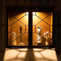 A trophy case with unusually shaped trophies inside, such as a hand and a tin can