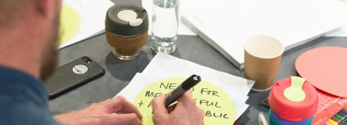 Man making notes on a round table