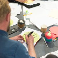 Man making notes on a round table