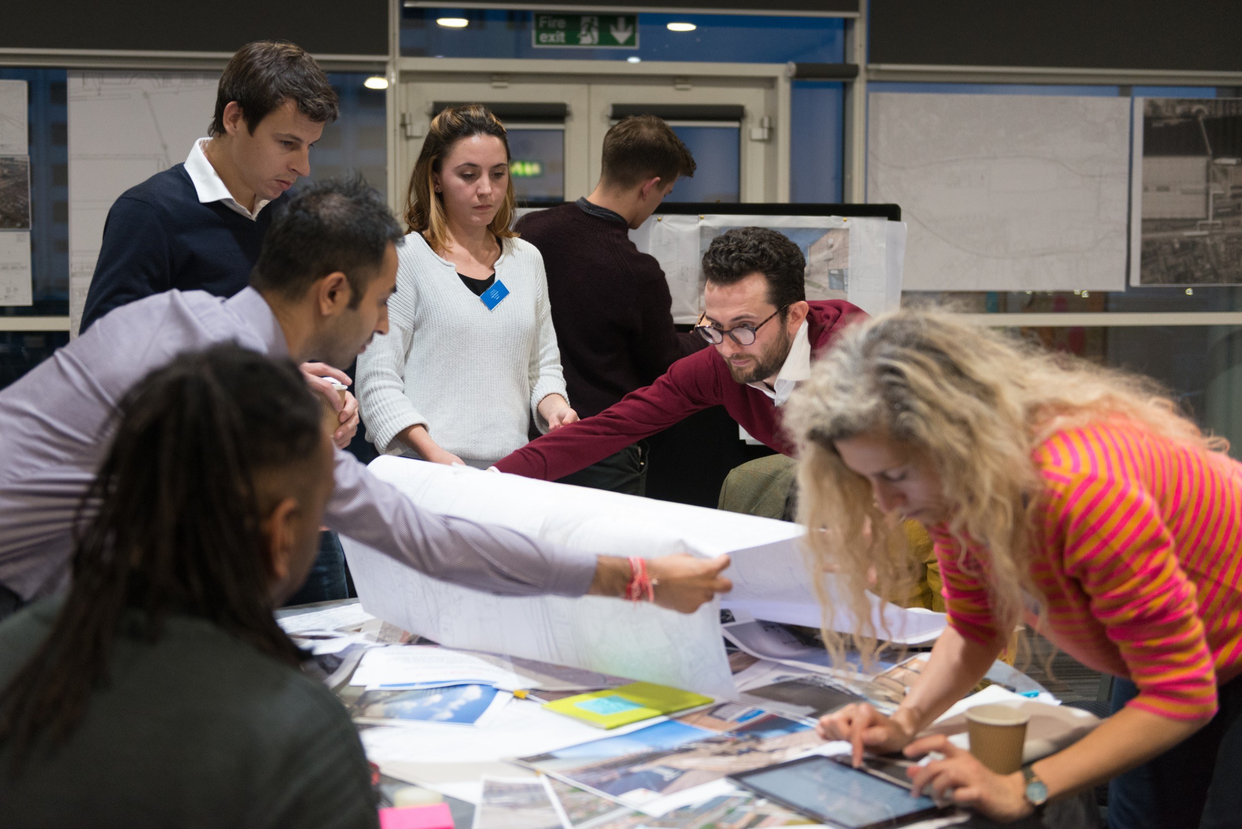 Group of people working together with large diagrams