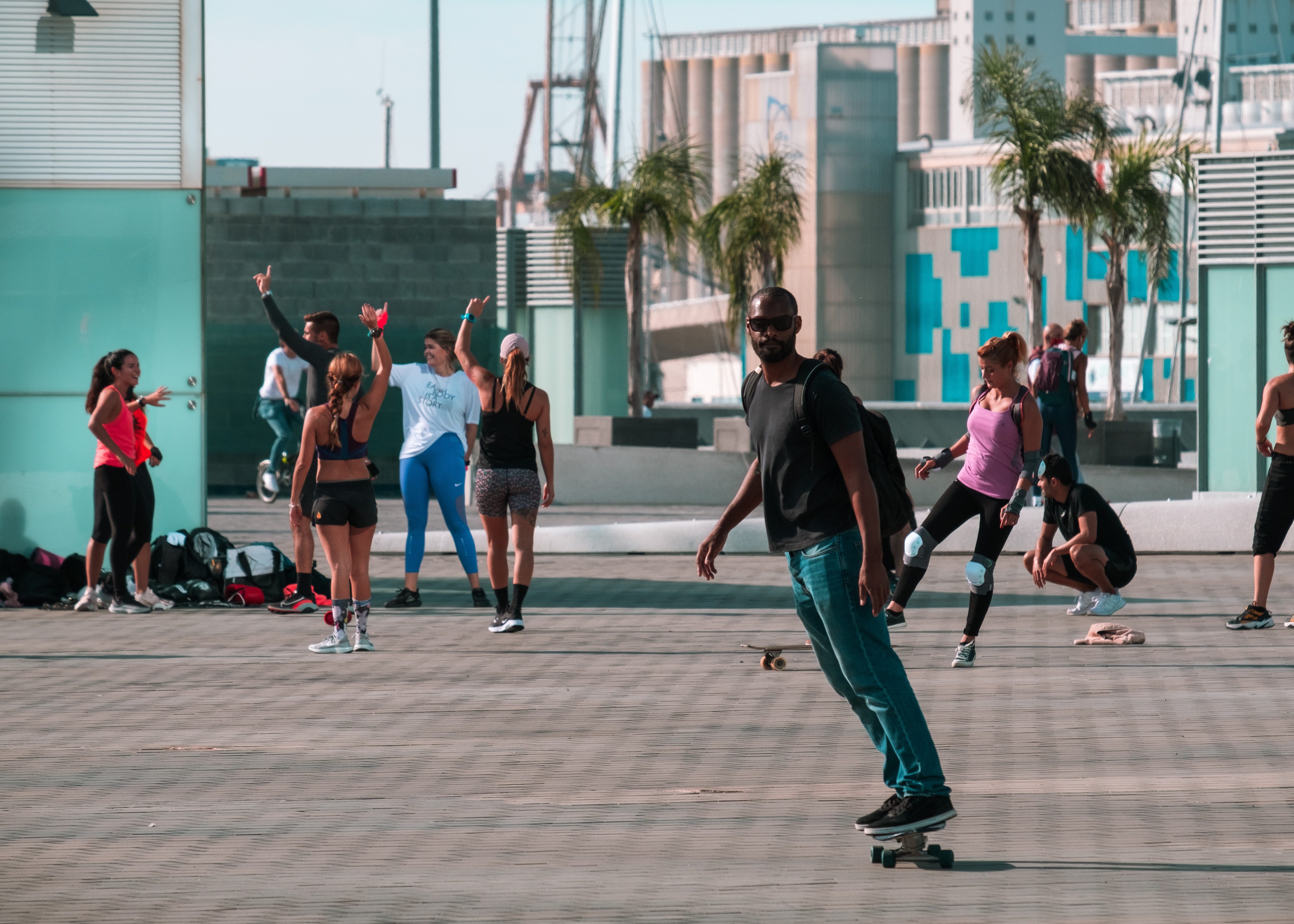 Skateboarder rolling down paved walkway in Barcelona