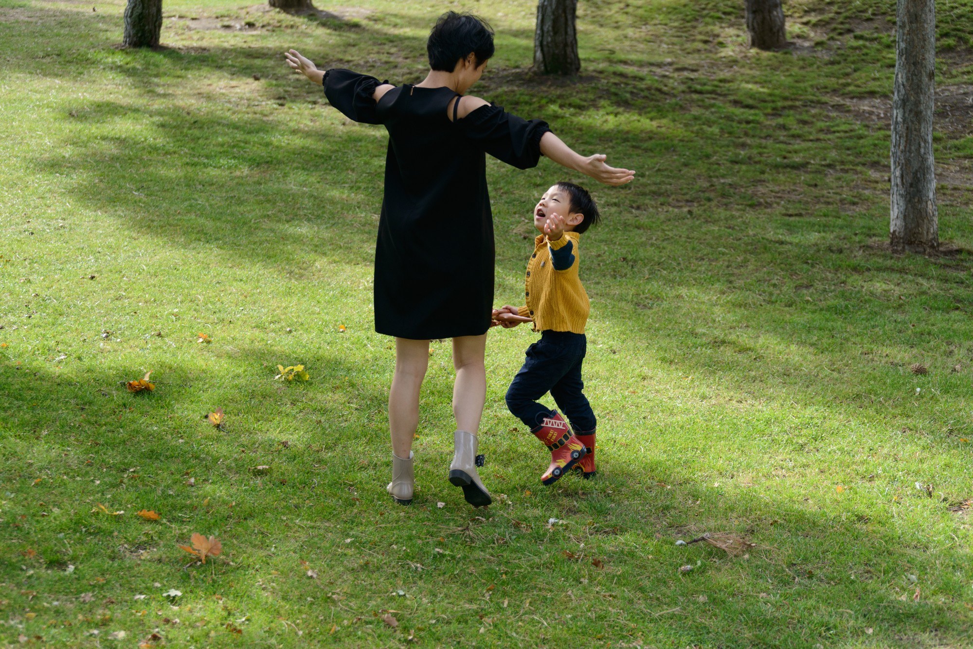 Woman playing with toddler in the park