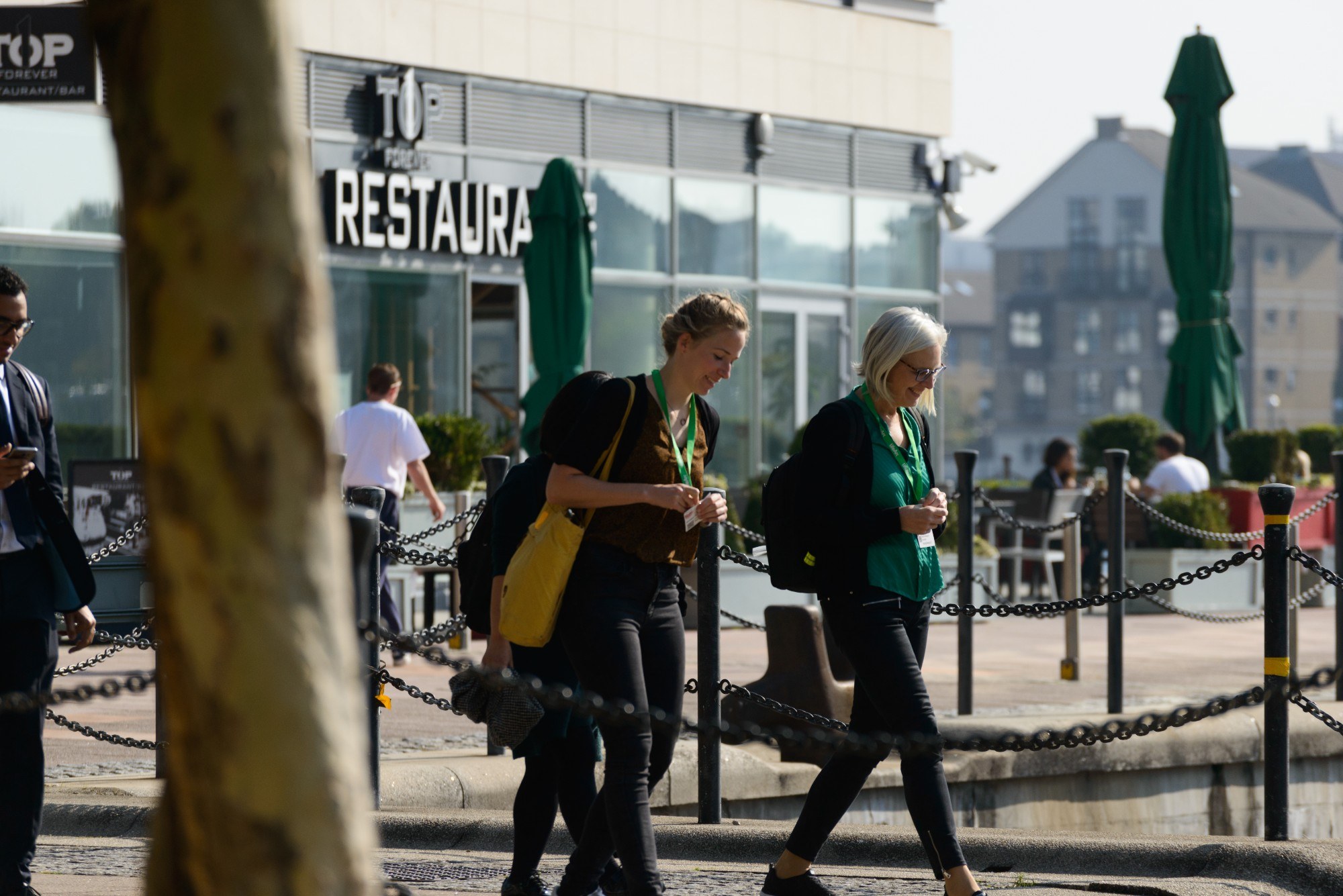 People walking past Top 1 Forever restaurant on Royal Victoria Dock