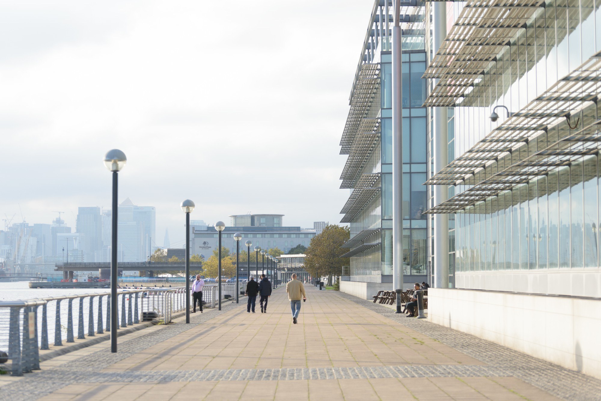 Pavement next to dock with buildings on one side